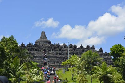 Group of people in temple against sky