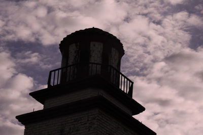 Low angle view of building against cloudy sky
