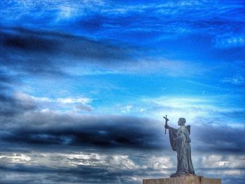 Low angle view of statue against cloudy sky