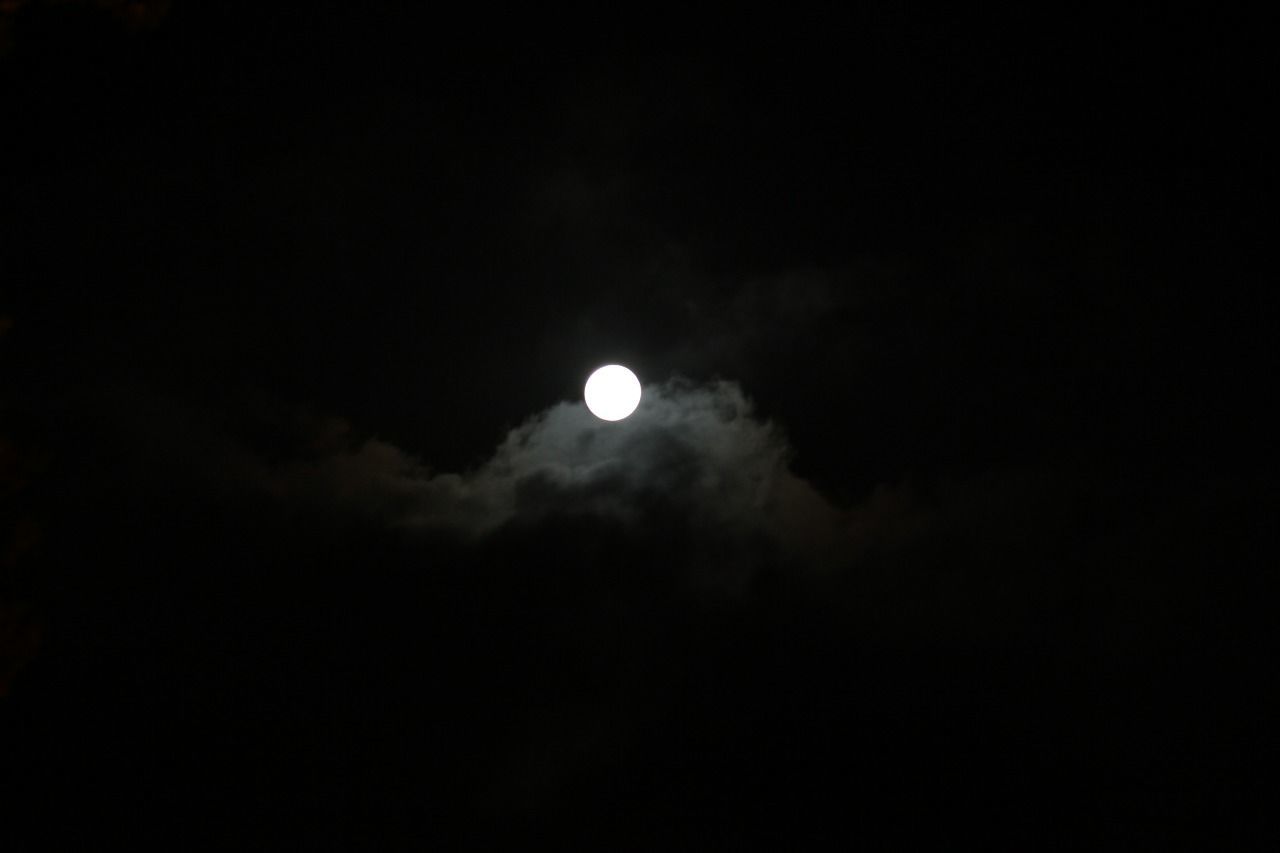 sky, night, moon, astronomy, space, beauty in nature, low angle view, scenics - nature, copy space, no people, dark, nature, moonlight, tranquil scene, space exploration, tranquility, cloud - sky, outdoors, crescent, natural phenomenon, planetary moon, full moon, eclipse, black background, space and astronomy