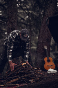 People working on tree trunk in forest