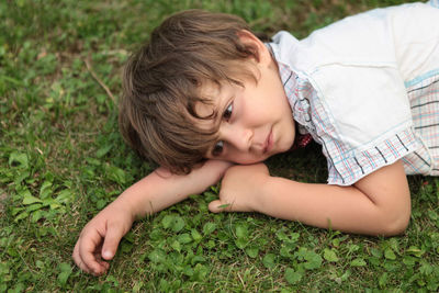 Portrait of cute girl lying on grass