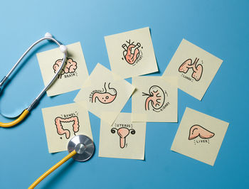 Directly above shot of stethoscope on blue background