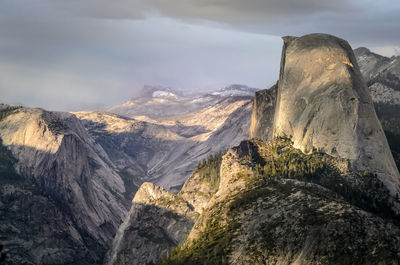 Scenic view of mountain against cloudy sky