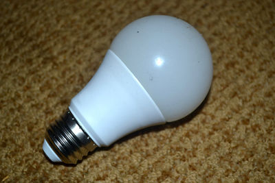 Close-up of light bulb on table