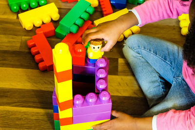 Boy playing with toy toys on floor