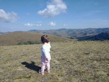 Full length of girl on mountain against sky