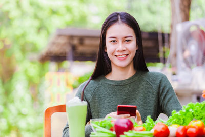 Portrait of smiling woman holding food