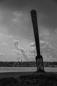 Cross on field against sky