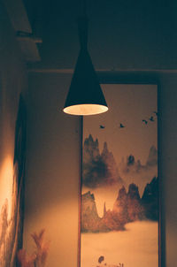 Close-up of illuminated lamp against sky at home