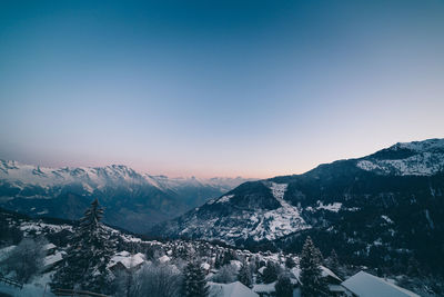 Scenic view of snowcapped mountains against clear sky during winter