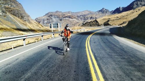 Man riding bicycle on road