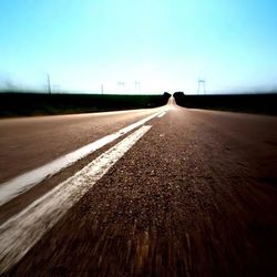 Surface level of road against clear sky