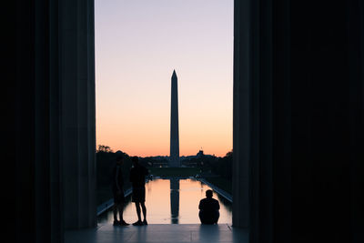 Silhouette of building against sky during sunset