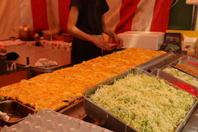 Man preparing food at market stall