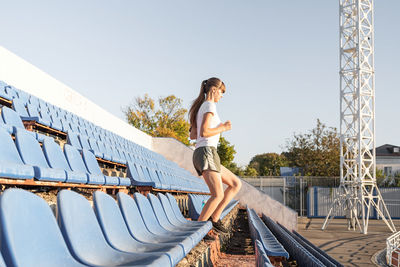 Active lifestyle. teenager girl working out at the staduim running down the stairs