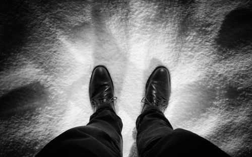 Low section of man standing on floor