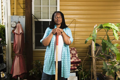 Portrait of african-american woman standing in front of her house