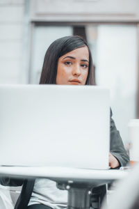 Portrait of young woman using digital tablet