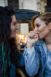 Portrait of young woman sitting on street