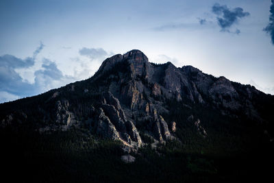 Low angle view of rocky mountain against sky