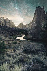 Scenic view of land and mountains against sky