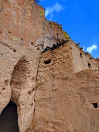 Low angle view of rock formation against sky