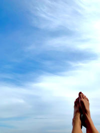 Low section of woman legs against sky