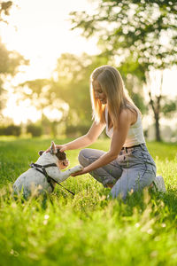 Woman with dog on field