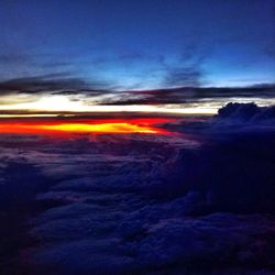 Scenic view of sea against cloudy sky at sunset