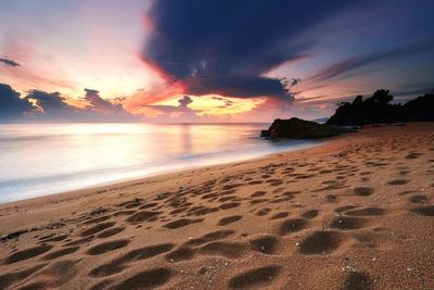 View of beach against cloudy sky