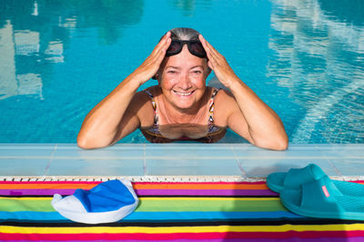 Portrait of a smiling young woman swimming pool