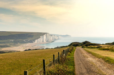 Scenic view of road by land against sky