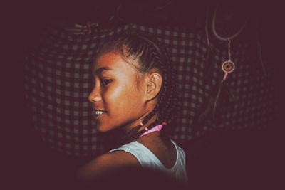 Close-up of girl looking away in darkroom