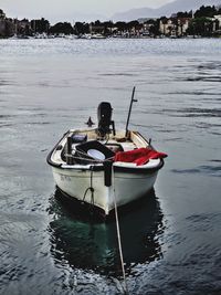 Boat moored in sea against sky