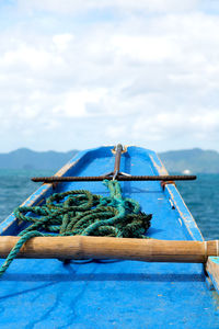 Boat moored on sea against sky