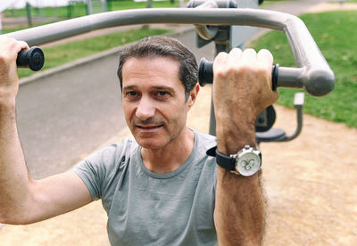 Portrait of man exercising at park