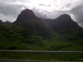 Scenic view of mountains against cloudy sky