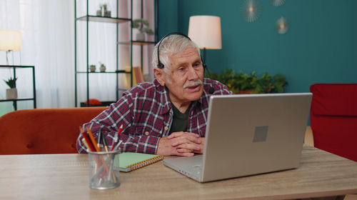 Man using laptop at home