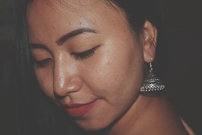 Close-up of young woman wearing earring