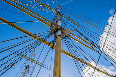 Low angle view of mast on sailboat against sky