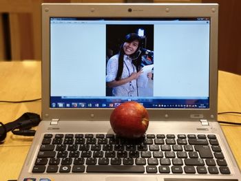 Young woman using phone on table