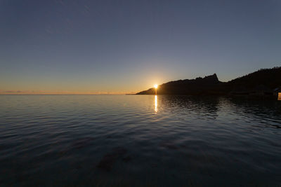 Scenic view of sea against clear sky during sunset