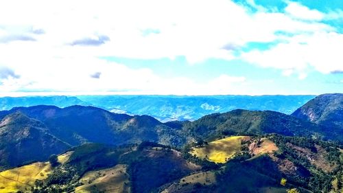 Scenic view of mountains against cloudy sky