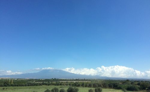 Countryside landscape against mountain range