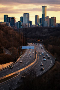 High angle view of street amidst buildings against sky during sunset