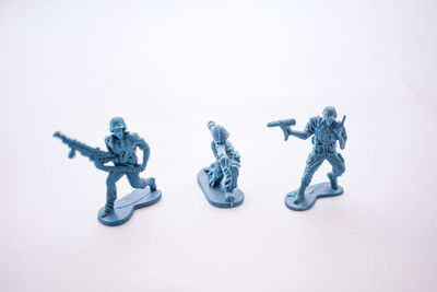 Close-up of figurine over white background