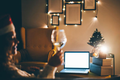 Digital composite image of woman using laptop on table