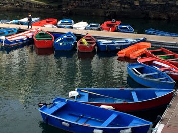 Boats moored at harbor