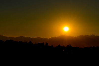 Scenic view of silhouette mountains against sky during sunset